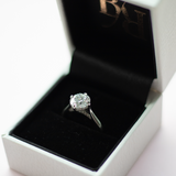 Round brilliant cut diamond with a hidden halo, platinum claws, diamond set bridge and platinum band. Handmade luxury in the UK and Ireland for engagement rings, wedding bands, eternity rings and classic jewellery.