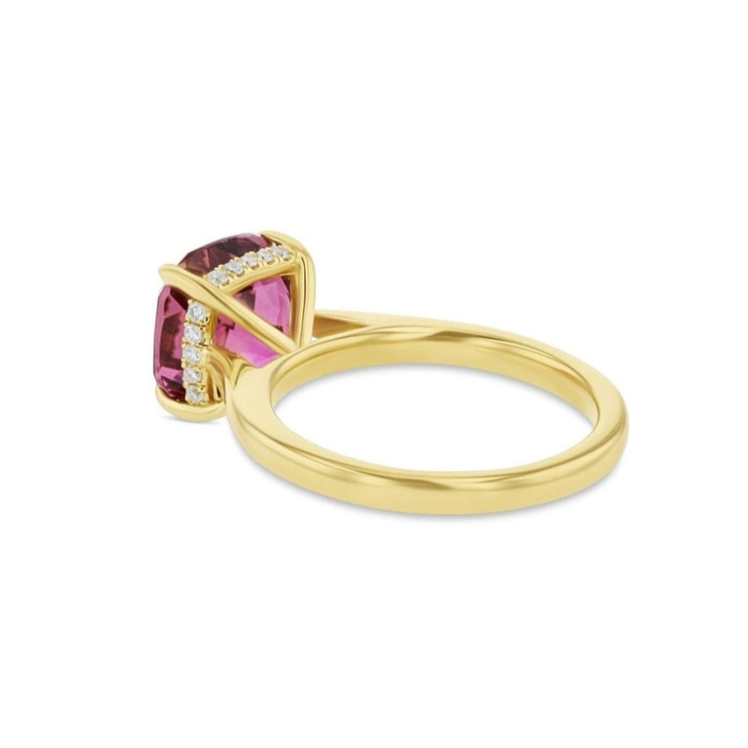 Cushion cut pink tourmaline set with a hidden halo in 18ct rose gold. Handmade luxury in the UK and Ireland for engagement rings, wedding bands, eternity rings and classic jewellery.