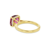 Cushion cut pink tourmaline set with a hidden halo in 18ct rose gold. Handmade luxury in the UK and Ireland for engagement rings, wedding bands, eternity rings and classic jewellery.