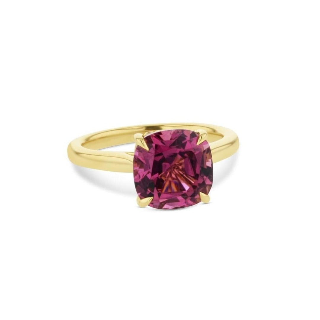 Cushion cut pink tourmaline set with a hidden halo in 18ct rose gold. Handmade luxury in the UK and Ireland for engagement rings, wedding bands, eternity rings and classic jewellery.