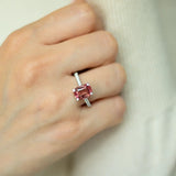 Cushion cut pink-orange tourmaline with diamond set claws, and diamond set band. Handmade luxury in the UK and Ireland for engagement rings, wedding bands, eternity rings and classic jewellery.