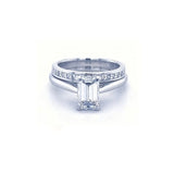 Diamond ring with emerald-cut center stone on a white background