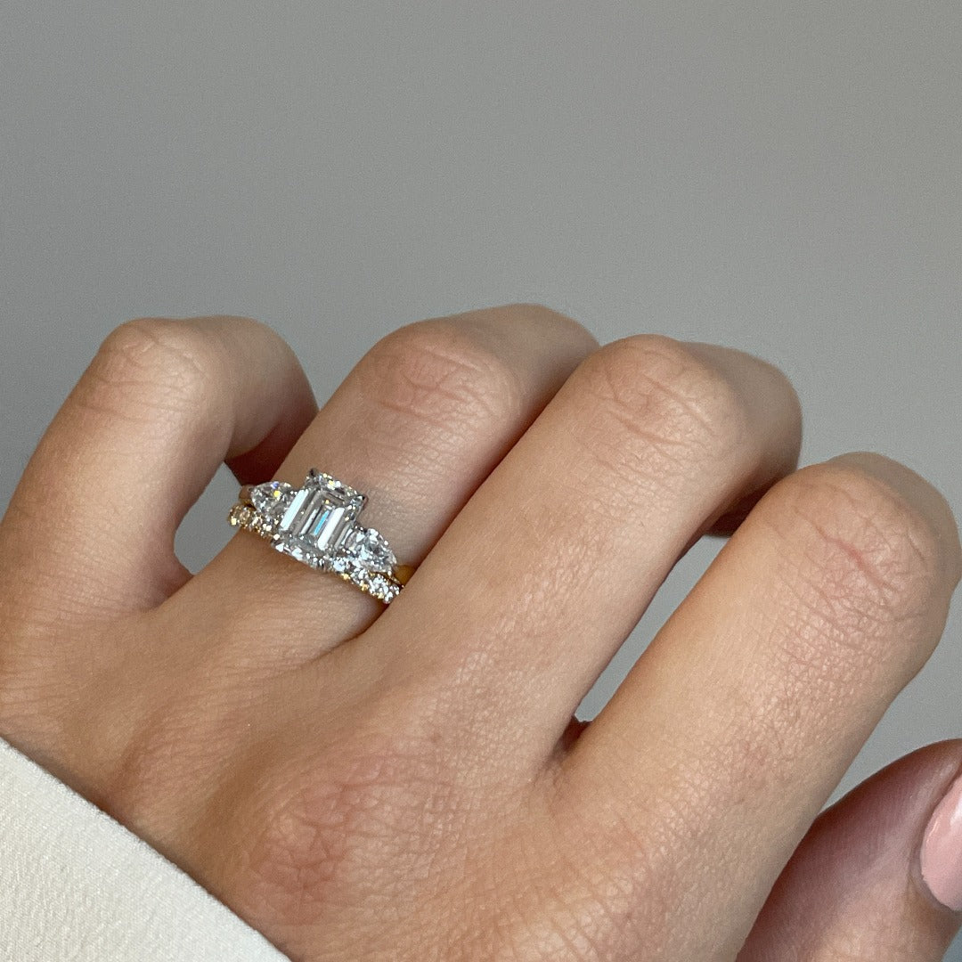 Platinum and emerald cut diamond engagement ring featuring pear cut shoulders and a diamond wedding band for bridal wear in Dublin, London, Manchester, Ireland and the UK. Fine jewellery, engagement and wedding rings, Bridal jewellery, Irish and British craftsmanship