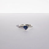 Heart shaped blue sapphire bezel set with a hidden diamond halo in platinum. Handmade luxury in the UK and Ireland for engagement rings, wedding bands, eternity rings and classic jewellery.