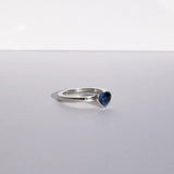 Heart shaped blue sapphire bezel set with a hidden diamond halo in platinum. Handmade luxury in the UK and Ireland for engagement rings, wedding bands, eternity rings and classic jewellery.