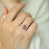 Cushion cut pink-orange tourmaline with diamond set claws, and diamond set band. Handmade luxury in the UK and Ireland for engagement rings, wedding bands, eternity rings and classic jewellery.