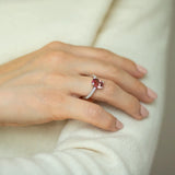 Cushion cut pink-orange tourmaline with diamond set claws, and diamond set band. Handmade luxury in the UK and Ireland for engagement rings, wedding bands, eternity rings and classic jewellery.