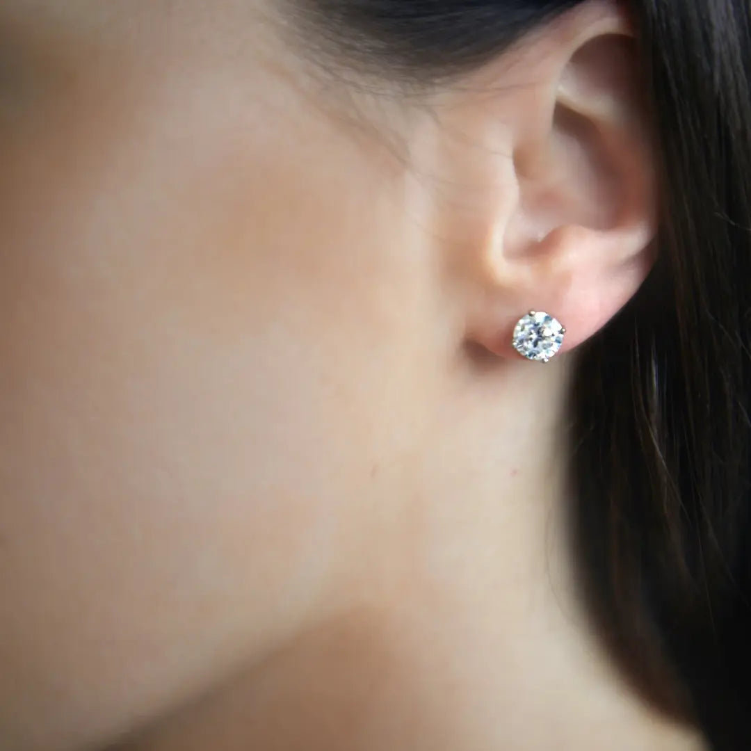 Round Brilliant Cut Diamond studs in platinum with talon claws. Handmade luxury in the UK and Ireland for engagement rings, wedding bands, eternity rings and classic jewellery.