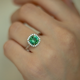 Cushion cut green tourmaline set with 18ct yellow gold claws and a diamond halo in platinum. Handmade luxury in the UK and Ireland for engagement rings, wedding bands, eternity rings and classic jewellery.
