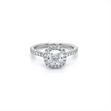Cushion cut diamond set with a diamond halo and diamond shoulders in platinum. Handmade luxury in the UK and Ireland for engagement rings, wedding bands, eternity rings and classic jewellery.