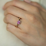 Rose gold and sapphire ring featuring a hidden halo design and emerald cut pink sapphire cut gemstone in Dublin, London, Manchester, Ireland and the UK. Fine jewellery, engagement and wedding rings, Bridal luxury, Irish and British craftsmanship