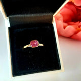 Rose gold and sapphire ring featuring a hidden halo design and emerald cut pink sapphire cut gemstone in Dublin, London, Manchester, Ireland and the UK. Fine jewellery, engagement and wedding rings, Bridal luxury, Irish and British craftsmanship