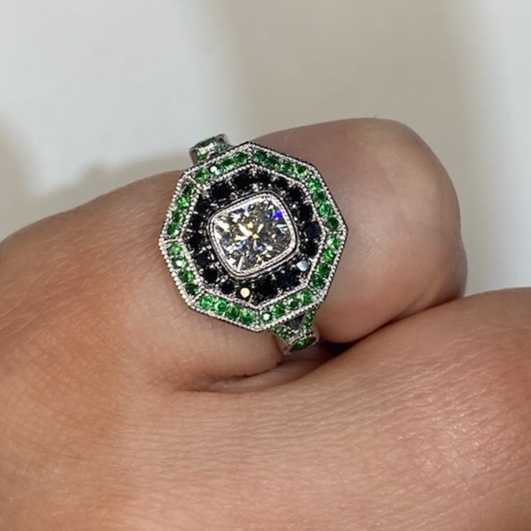 Stunning bespoke order for a 1ct cushion diamond halo style ring featuring a black diamond and tsavorite gemstone surround for an engagement in Dublin, London, Manchester, Ireland and the UK. Fine jewellery, engagement and wedding rings, Bridal luxury, Irish and British craftsmanship