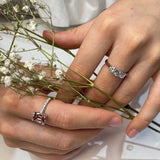 Cushion cut pink-orange tourmaline with diamond set claws, and diamond set band. Handmade luxury in the UK and Ireland for engagement rings, wedding bands, eternity rings and classic jewellery.