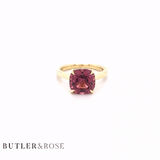 Cushion cut pink tourmaline set with a hidden halo in 18ct rose gold. Handmade luxury in the UK and Ireland for engagement rings, wedding bands, eternity rings and classic jewellery.