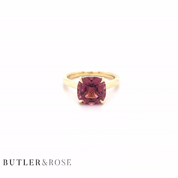 Cushion cut pink tourmaline set with a hidden halo in 18ct rose gold. Handmade luxury in the UK and Ireland for engagement rings, wedding bands, eternity rings and classic jewellery.