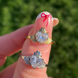 Two claddagh rings with diamond hearts and shamrock crowns. Modern desisgns of Claddagh ring. Two rings shown on on finger, in 18ct gold and platinum.