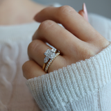 Emerald cut diamond with pear cut diamond shoulders and platinum claws and an 18ct yellow gold band. Handmade luxury in the UK and Ireland for engagement rings, wedding bands, eternity rings and classic jewellery.