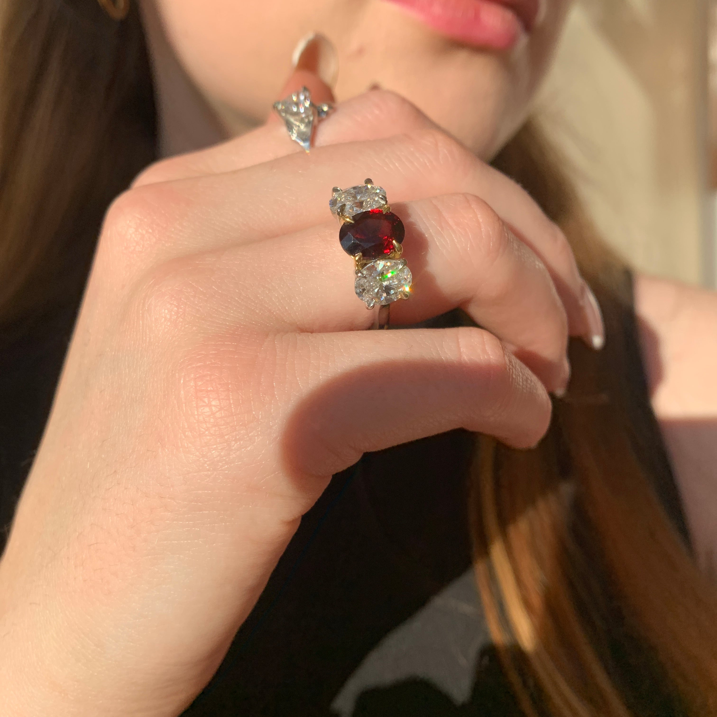 Butler & Rose handmade 3 stone garnet and oval cut diamond trilogy ring in platinum with talon claws perfect for an engagement or anniversary ring. fine quality and luxury details make this a classic