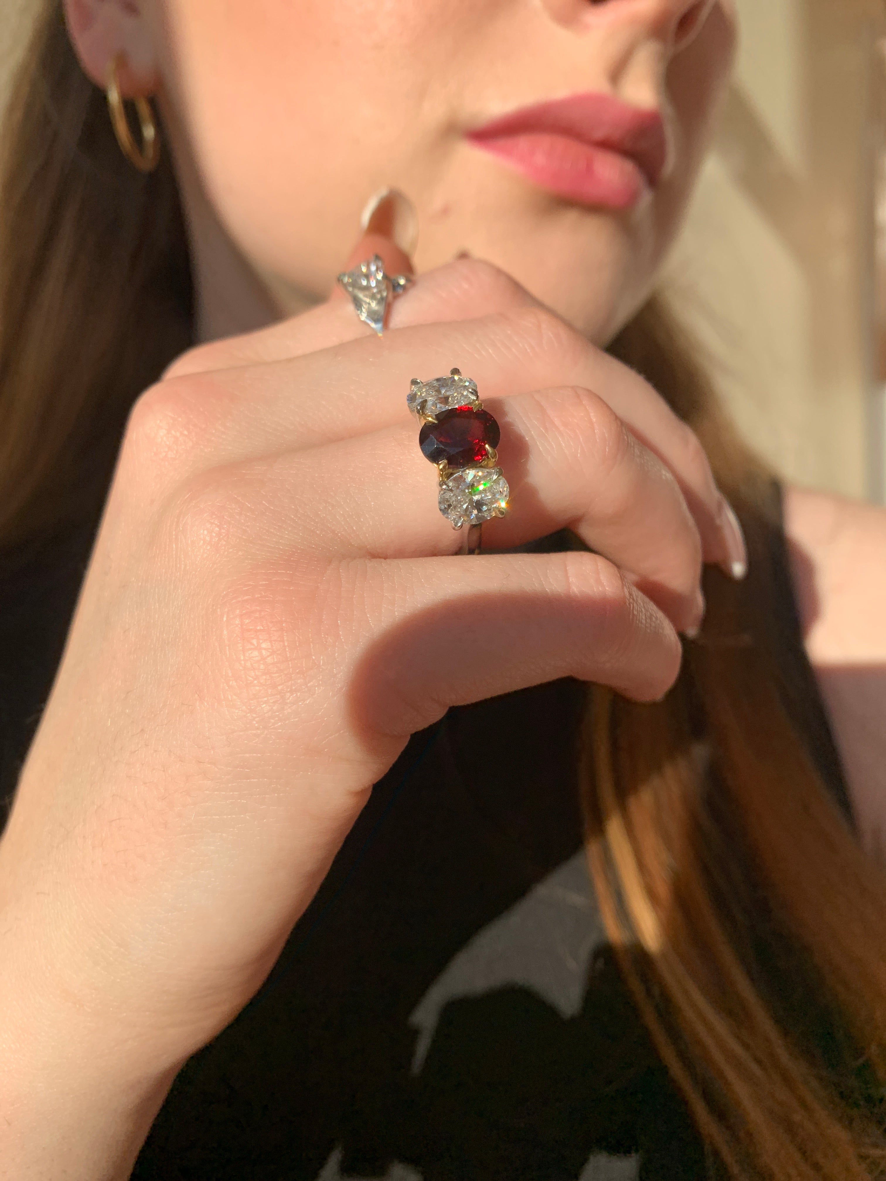 Butler & Rose handmade 3 stone garnet and oval cut diamond trilogy ring in platinum with talon claws perfect for an engagement or anniversary ring. fine quality and luxury details make this a classic