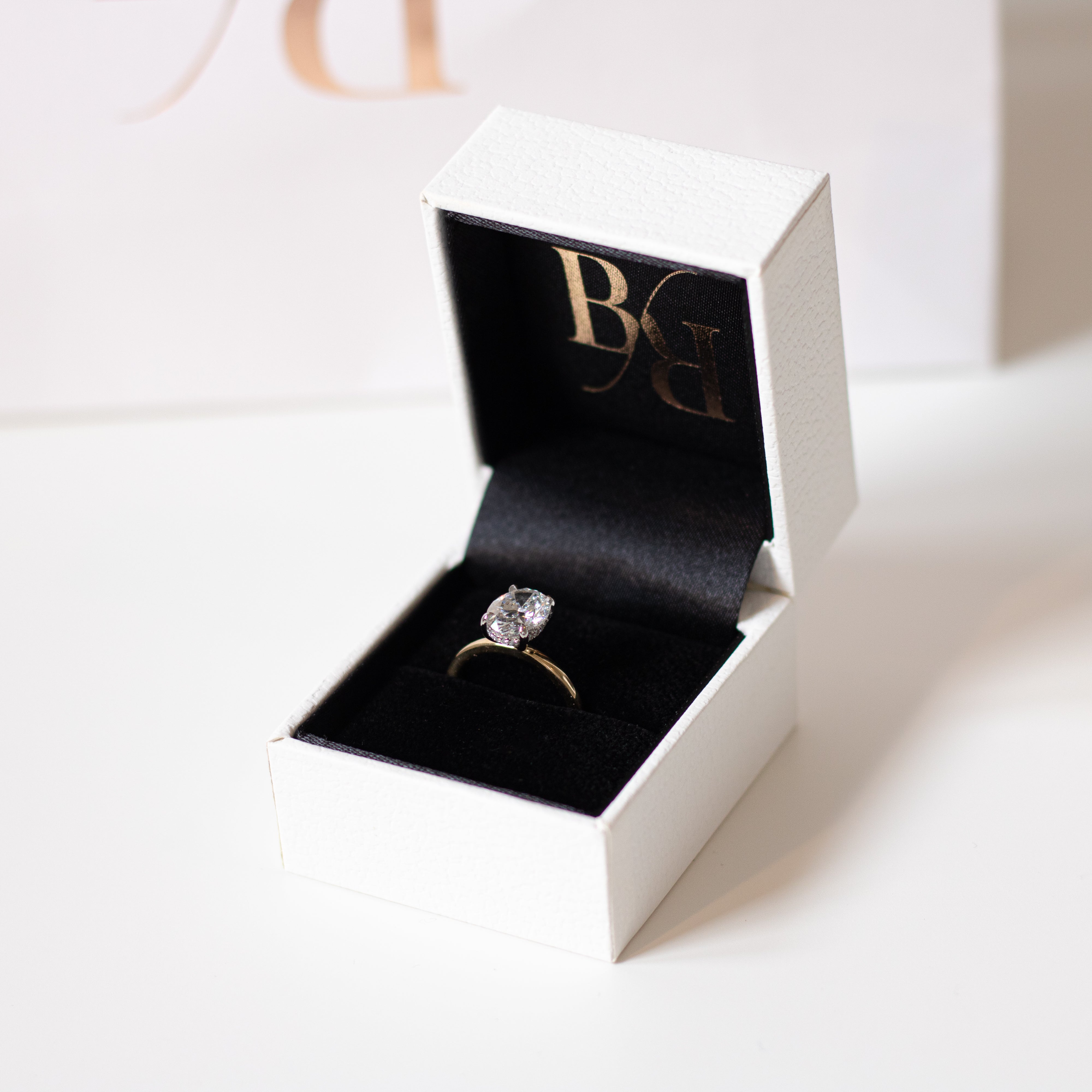 Oval diamond engagement ring, 18ct Gold band, and hidden diamond halo. Designer ring made in Dublin