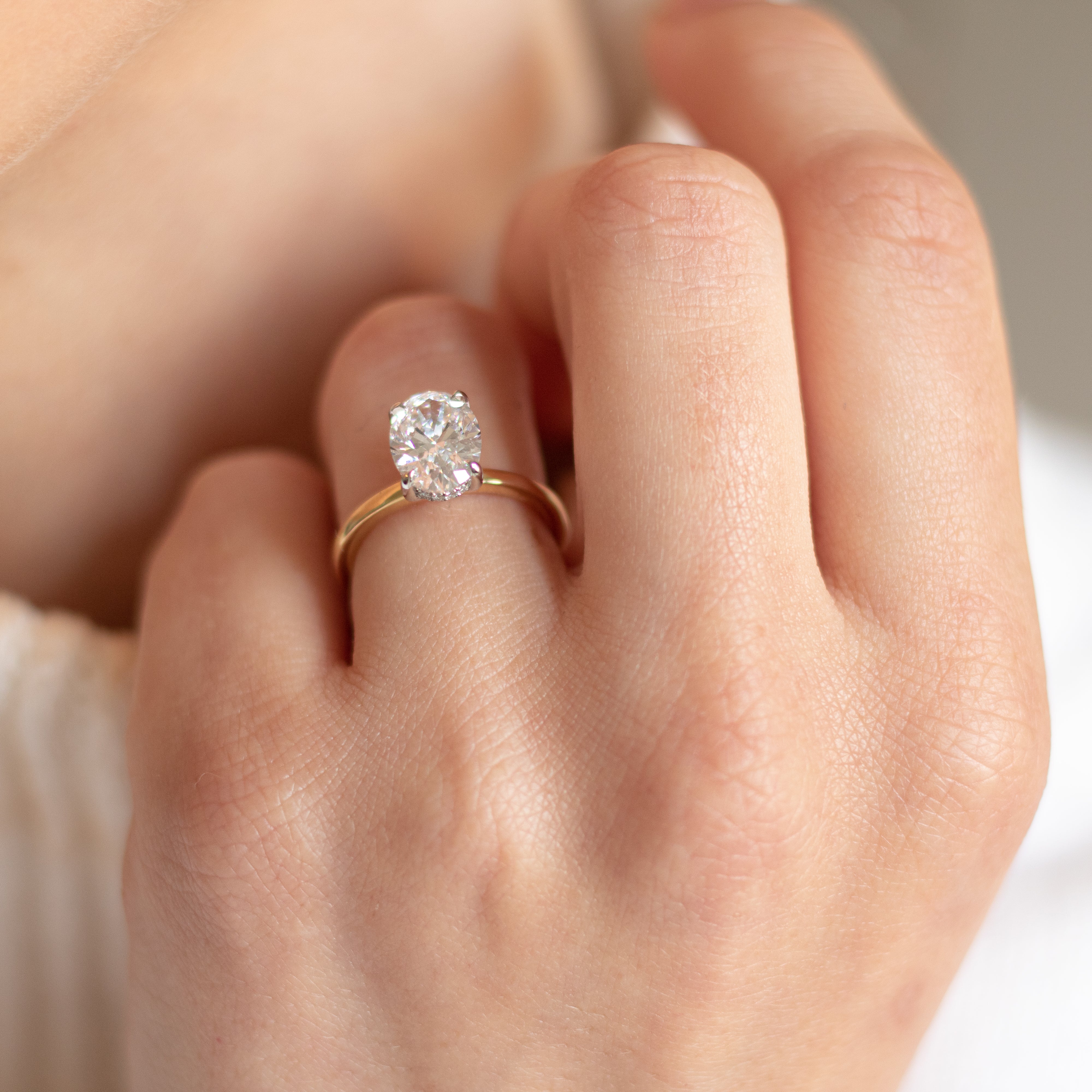 Oval diamond engagement ring, 18ct Gold band, and hidden diamond halo. Designer ring made in Dublin