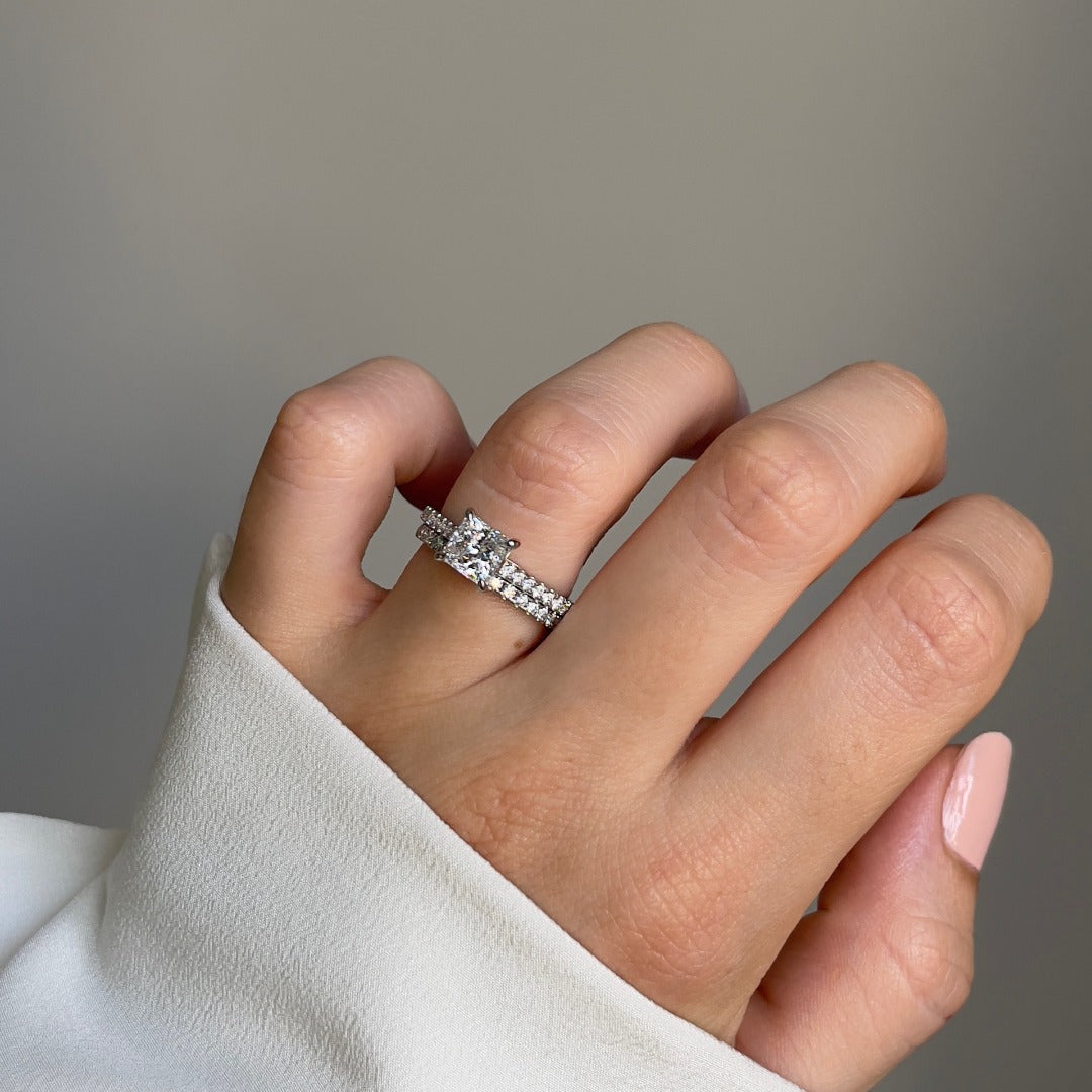 Princess cut diamond with a diamond set band, and platinum claws. Handmade luxury in the UK and Ireland for engagement rings, wedding bands, eternity rings and classic jewellery.