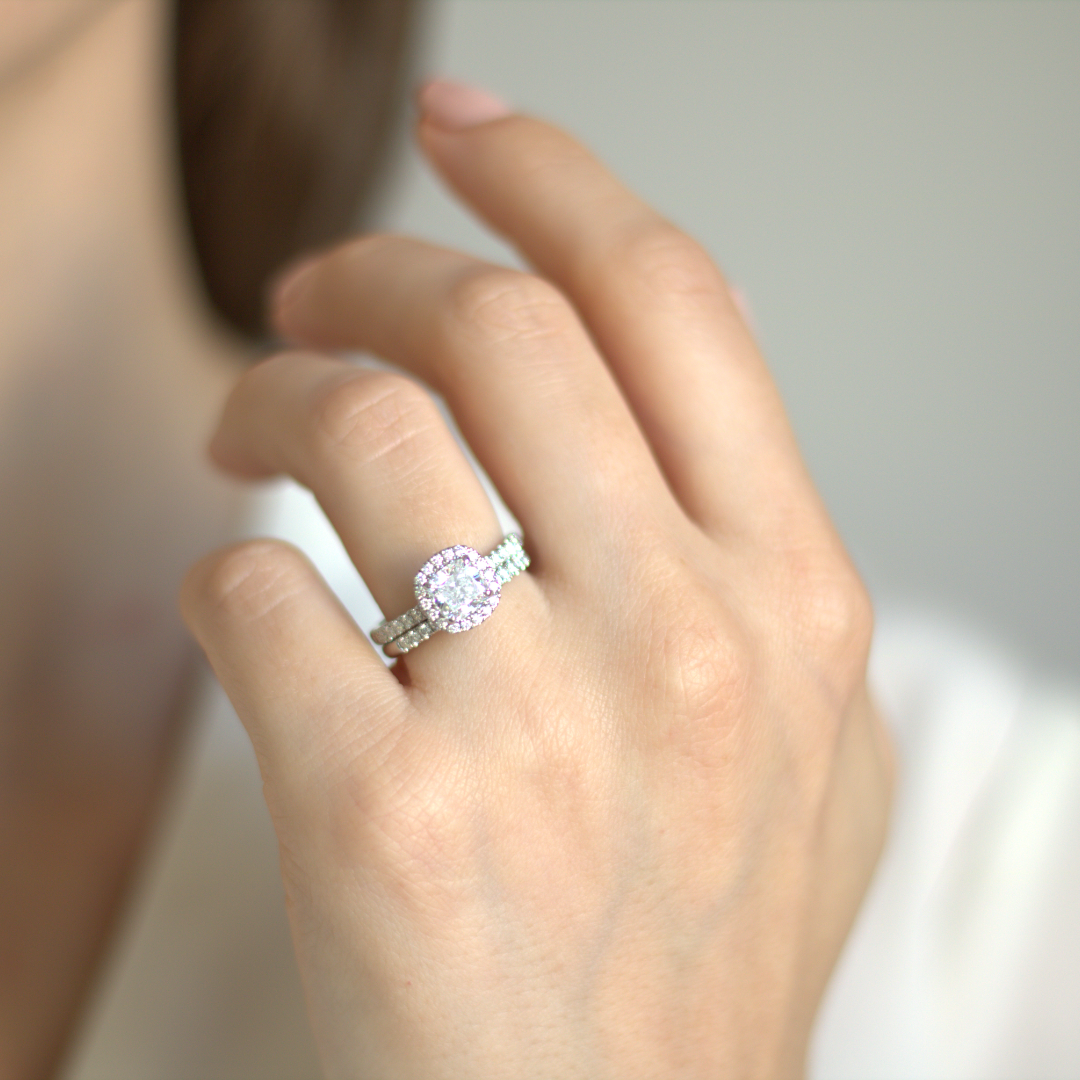 Cushion cut diamond set with a diamond halo and diamond shoulders in platinum. Handmade luxury in the UK and Ireland for engagement rings, wedding bands, eternity rings and classic jewellery.