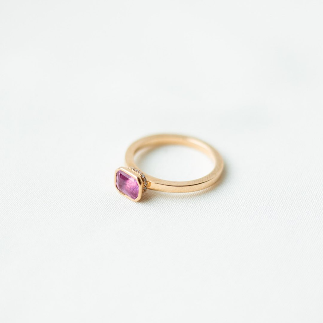 Rose gold and sapphire ring featuring a hidden halo design and emerald cut pink sapphire cut gemstone in Dublin, London, Manchester, Ireland and the UK. Fine jewellery, engagement and wedding rings, Bridal luxury, Irish and British craftsmanship