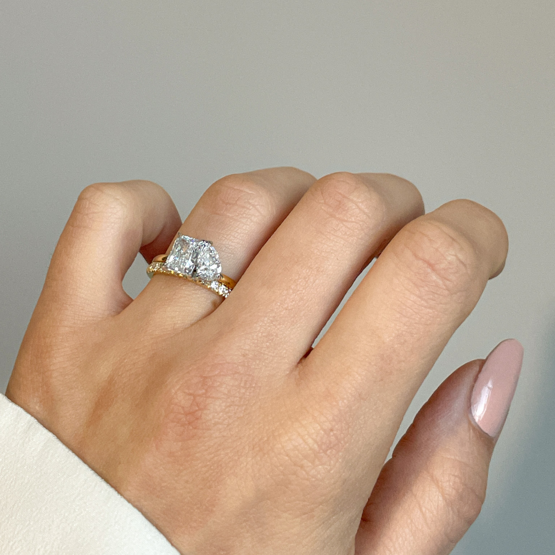 Toi et Moi with radiant cut and pear cut diamonds with platinum claws on an 18ct yellow gold band. Handmade luxury in the UK and Ireland for engagement rings, wedding bands, eternity rings and classic jewellery.