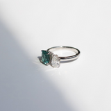 Toi et Moi with a green cushion cut tourmaline and pear cut diamond with platinum claws on a platinum band. Handmade luxury in the UK and Ireland for engagement rings, wedding bands, eternity rings and classic jewellery.