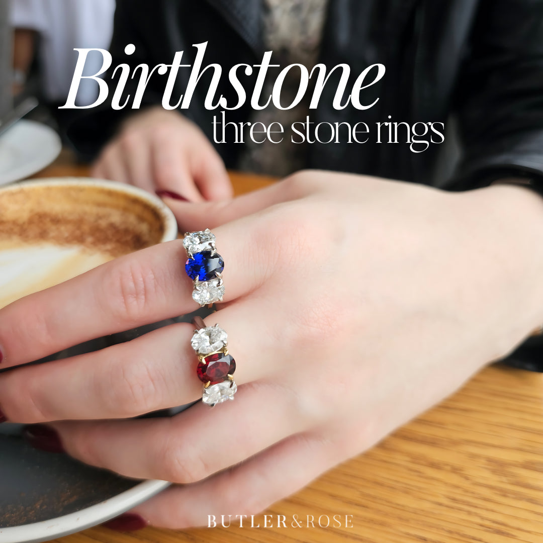 Butler & Rose handmade 3 stone garnet or sapphire,and oval cut diamond trilogy ring in platinum with talon claws perfect for an engagement or anniversary ring. fine quality and luxury details make this a classic