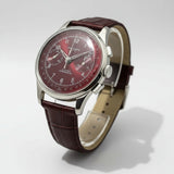 Wristwatch with brown leather strap and dark brown dial on a light background