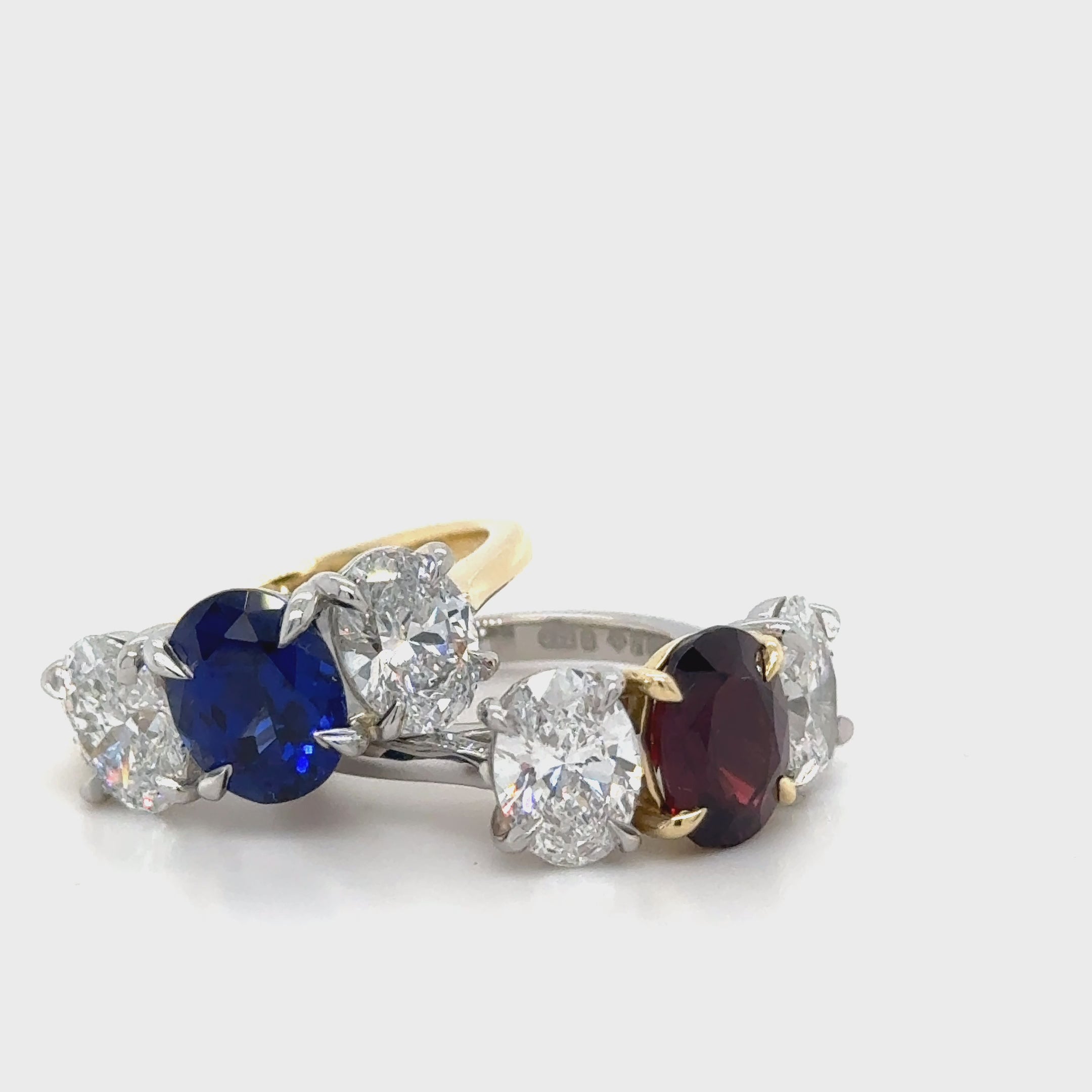 Butler & Rose handmade 3 stone garnet and oval cut diamond trilogy ring in platinum with talon claws perfect for an engagement or anniversary ring. fine quality and luxury details make this a classic