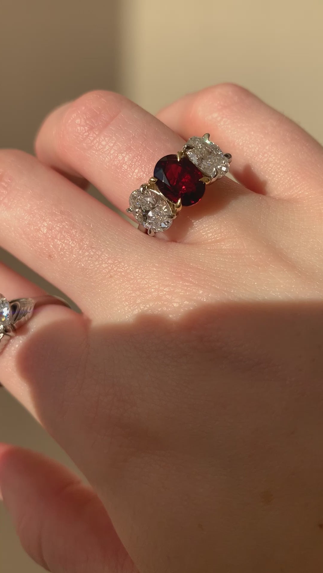 Butler & Rose handmade 3 stone garnet and oval cut diamond trilogy ring in platinum with talon claws perfect for an engagement or anniversary ring. fine quality and luxury details make this a classic