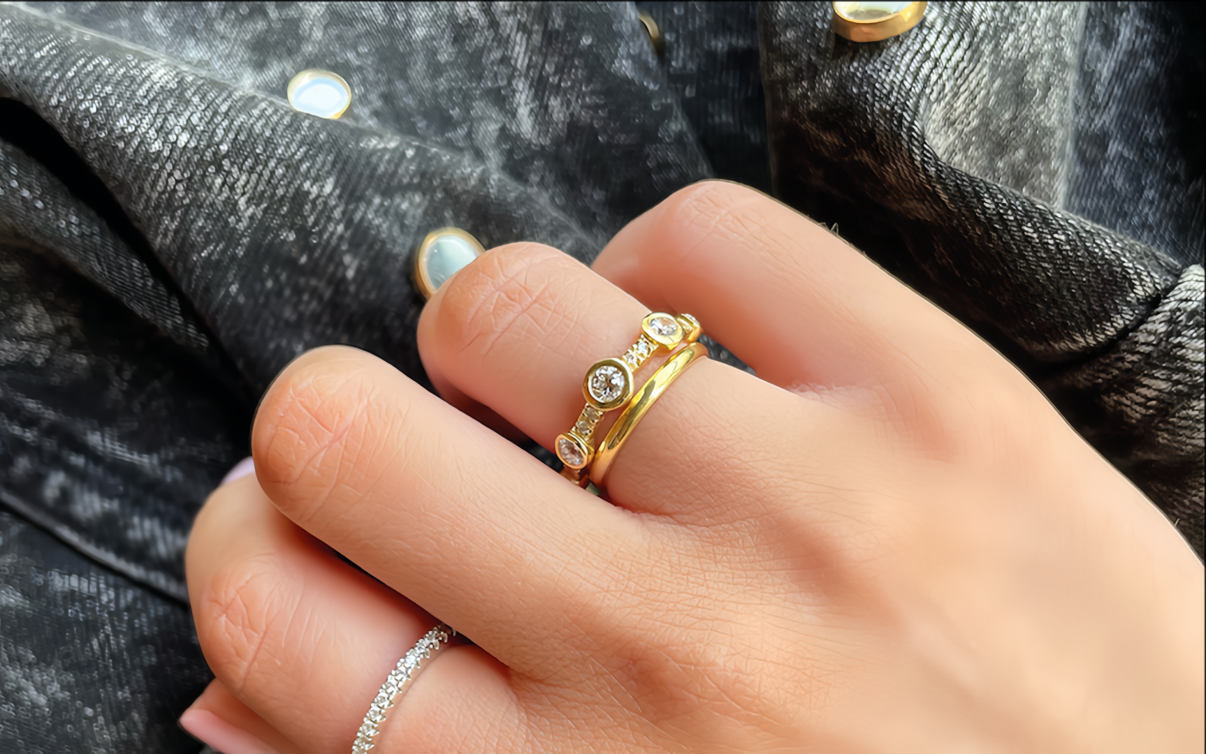 18ct Gold and diamond eternity ring with small stones on a person's finger designed by butler and rose jewellers in ireland. 