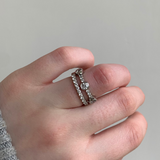 Three stone diamond eternity, wedding band in platinum with diamond pave band. Worn with Butler & Rose jewellers diamond pave eternity band in platinum.