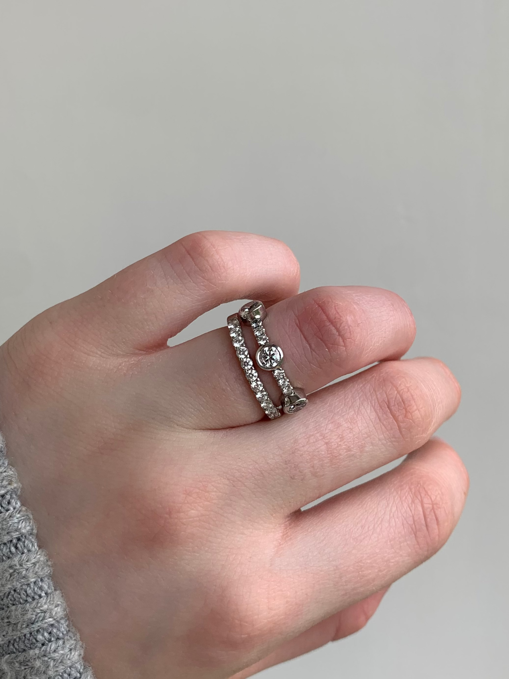 Three stone diamond eternity, wedding band in platinum with diamond pave band. Worn with Butler & Rose jewellers diamond pave eternity band in platinum.