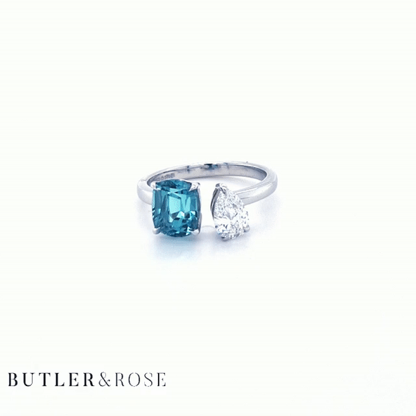 Toi et Moi with a green cushion cut tourmaline and pear cut diamond with platinum claws on a platinum band. Handmade luxury in the UK and Ireland for engagement rings, wedding bands, eternity rings and classic jewellery.